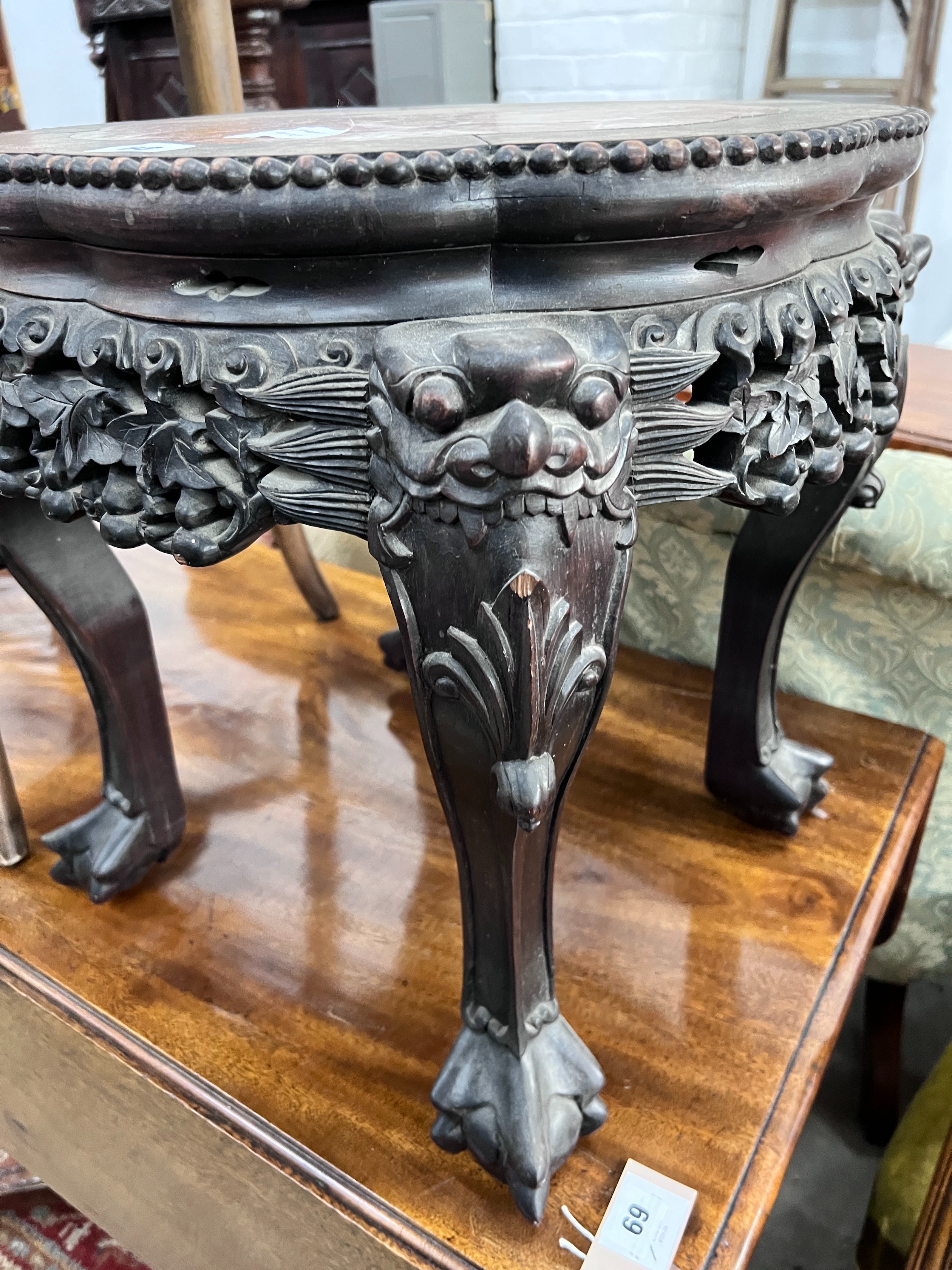 A Chinese carved hardwood rouge marble-topped jardiniere stand, diameter 43cm, height 46cm *Please note the sale commences at 9am.